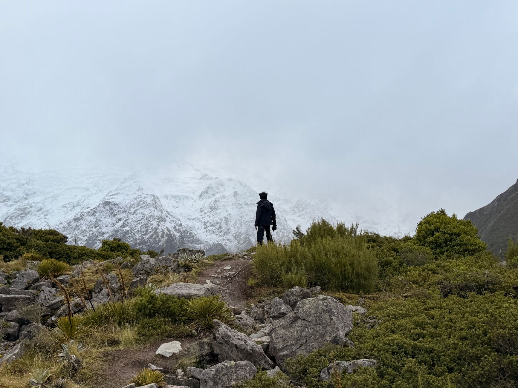 Hiker looking across Mount Cook National Park alpine range